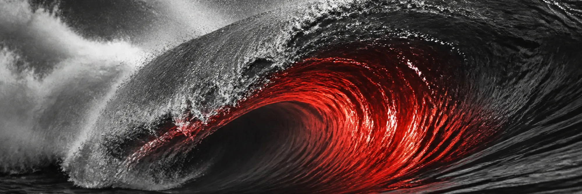 Monochrome wave breaking as a tube, red light glowing inside the barrel